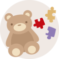 Roztomilý hnědý medvěd s barevnými puzzle kousky vedle něj.